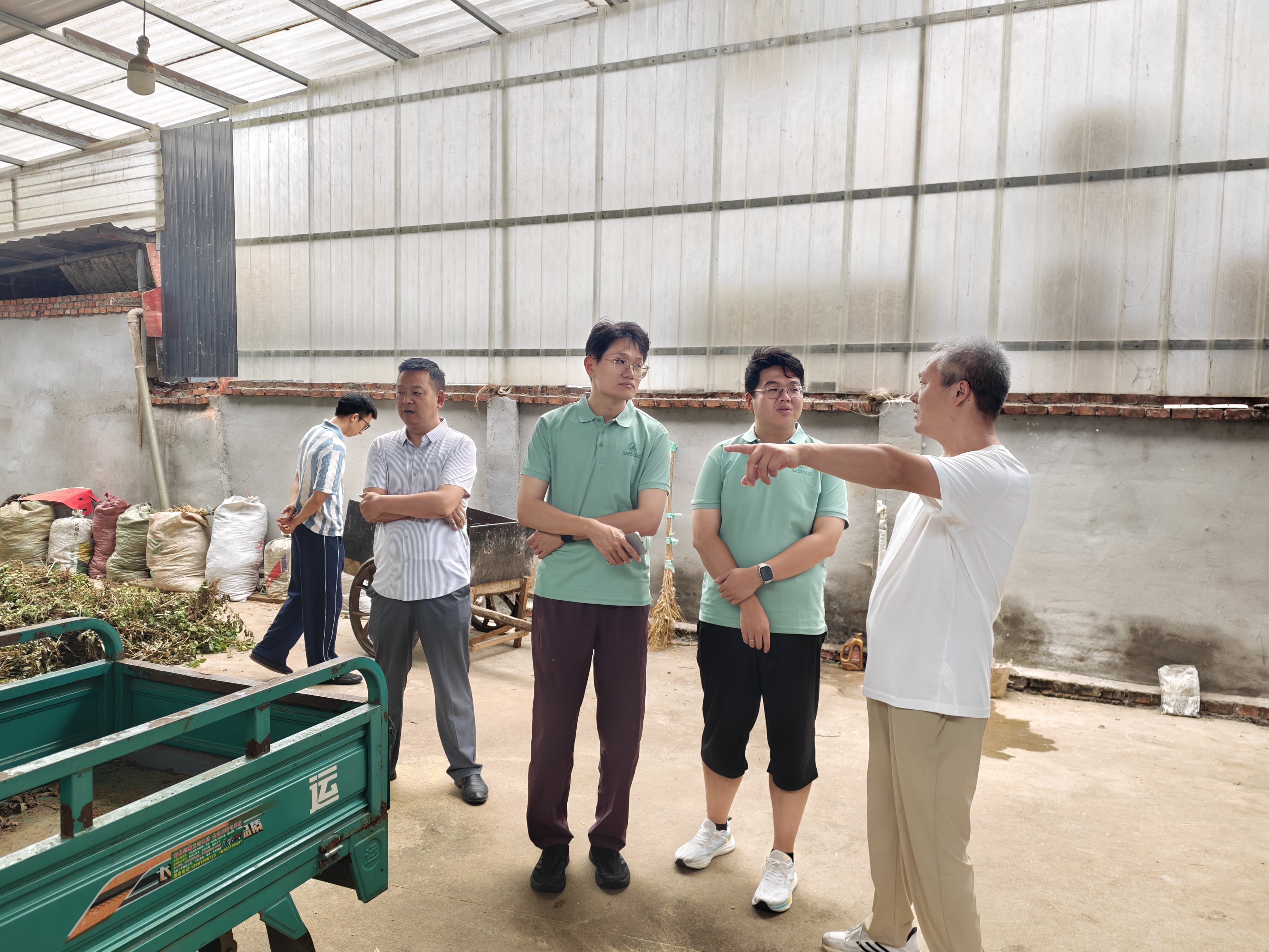 养殖户杨斌为队员们介绍奶山羊饲料配置特点.jpg